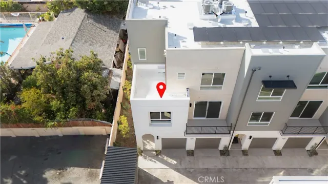 an aerial view of residential houses with outdoor space