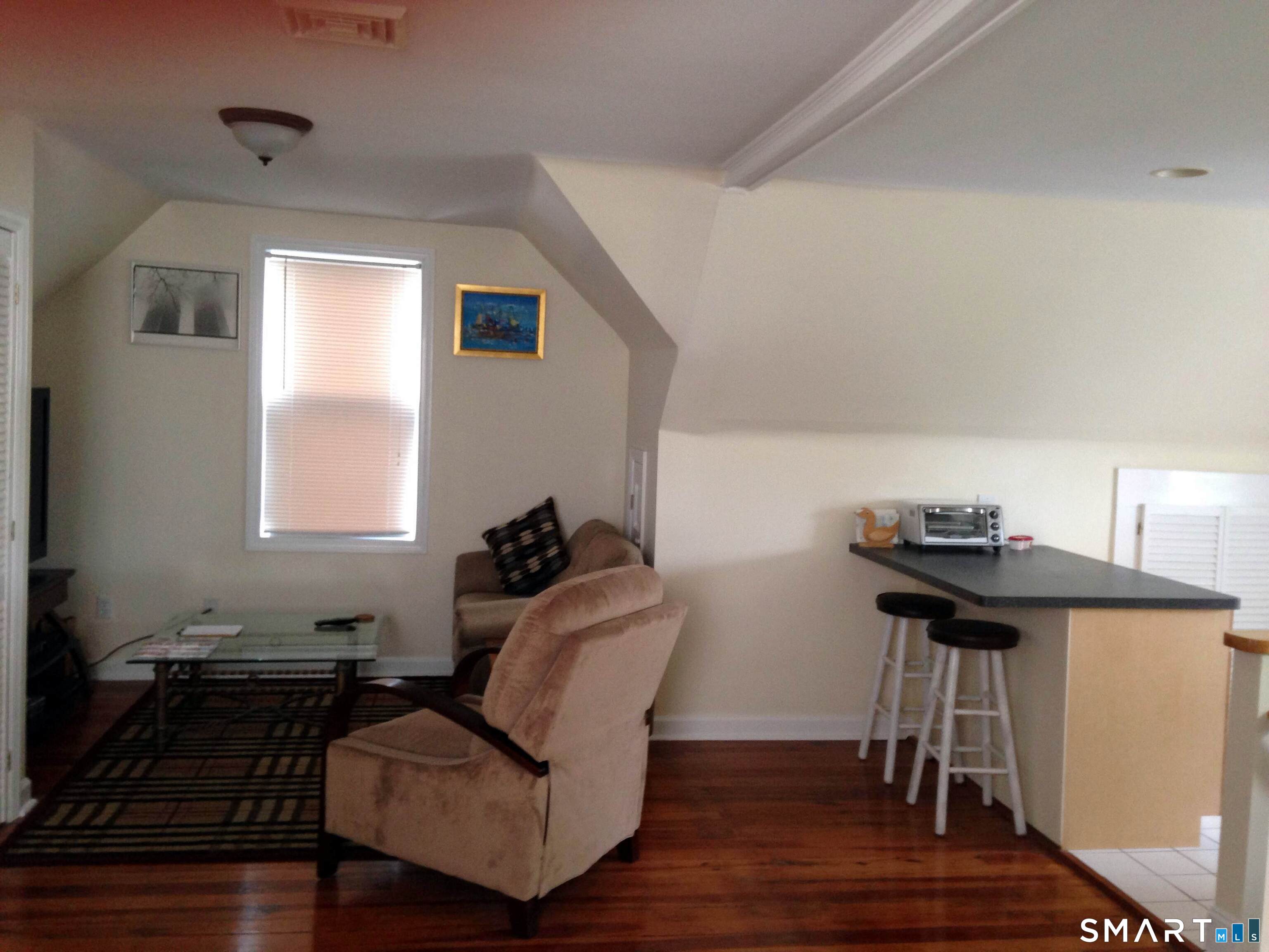 148 Alfred Street Bridgeport, CT 06605 - Photo 19 of 53 a living room with furniture and a window