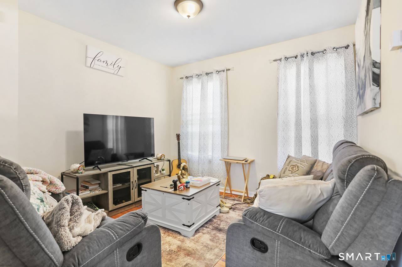 148 Alfred Street Bridgeport, CT 06605 - Photo 20 of 53 a living room with furniture and a flat screen tv