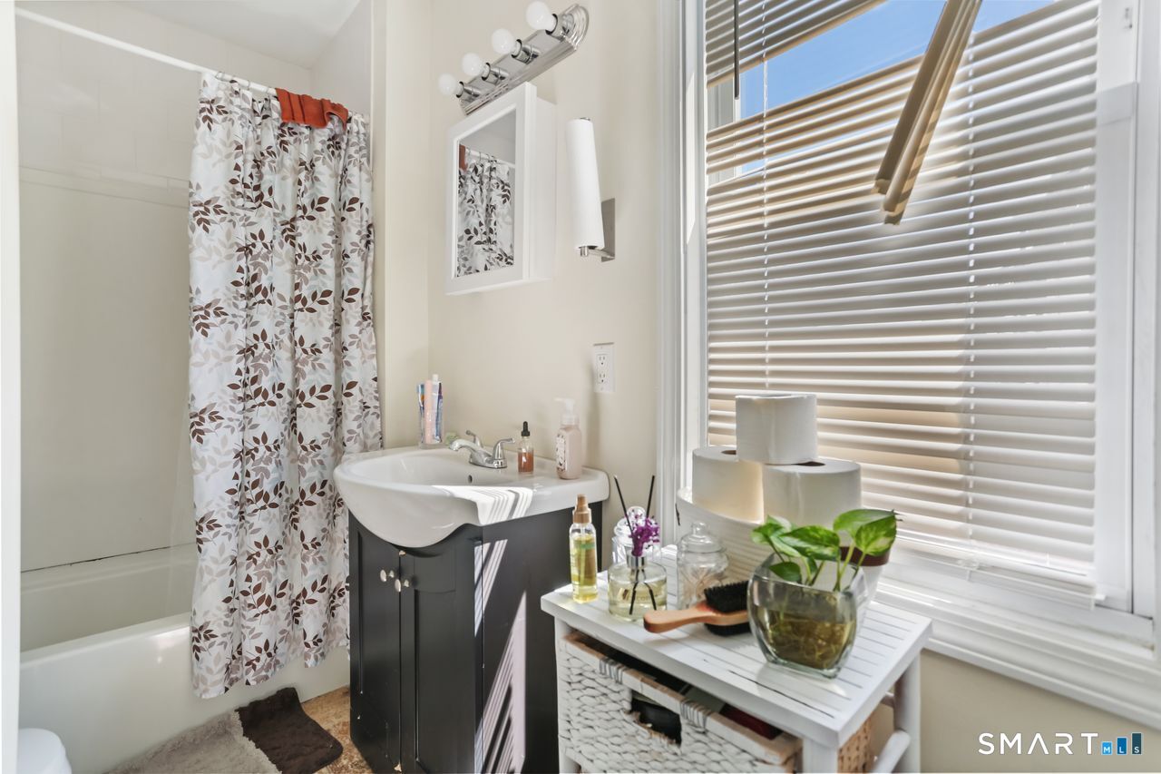 148 Alfred Street Bridgeport, CT 06605 - Photo 22 of 53 a bathroom with a sink a mirror and a shower