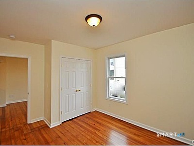 148 Alfred Street Bridgeport, CT 06605 - Photo 26 of 53 a view of an empty room with window and wooden floor