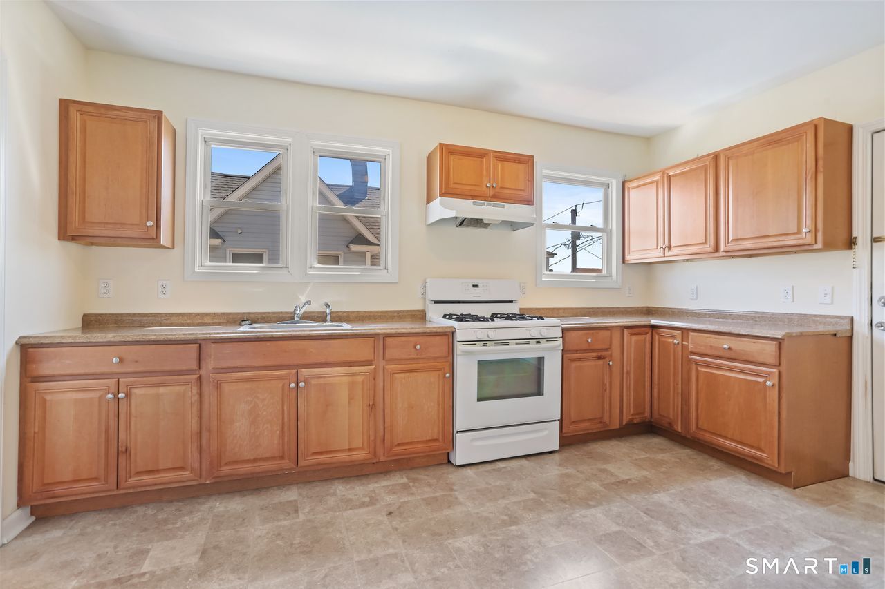 148 Alfred Street Bridgeport, CT 06605 - Photo 30 of 53 a kitchen with granite countertop a sink and cabinets