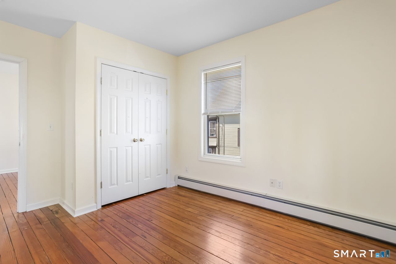 148 Alfred Street Bridgeport, CT 06605 - Photo 38 of 53 an empty room with wooden floor and windows