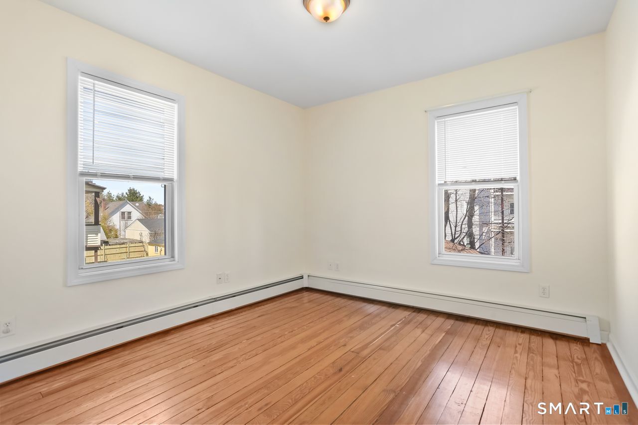 148 Alfred Street Bridgeport, CT 06605 - Photo 42 of 53 a view of an empty room with wooden floor and a window