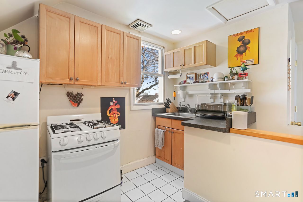 148 Alfred Street Bridgeport, CT 06605 - Photo 50 of 53 a kitchen with stainless steel appliances a stove a sink and a refrigerator