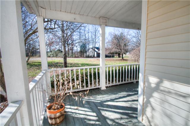7358 Crow Cut Road Fairview, TN 37062 - Photo 3 of 18 a view of a porch with a table and chairs