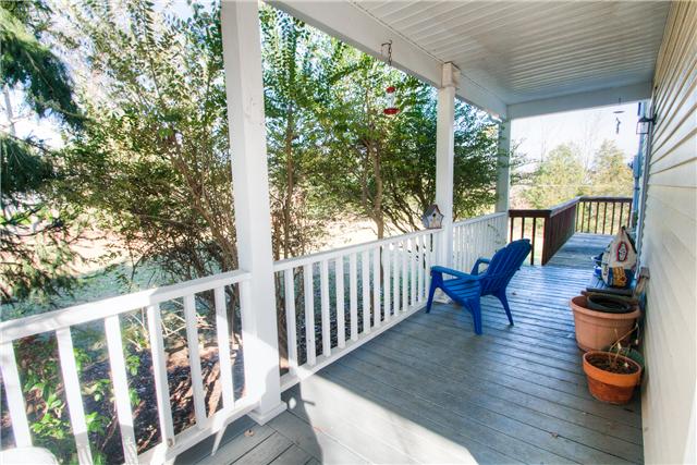 7358 Crow Cut Road Fairview, TN 37062 - Photo 4 of 18 a view of balcony with wooden floor and outdoor seating