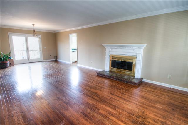 7358 Crow Cut Road Fairview, TN 37062 - Photo 5 of 18 a view of an empty room with wooden floor fireplace and a window