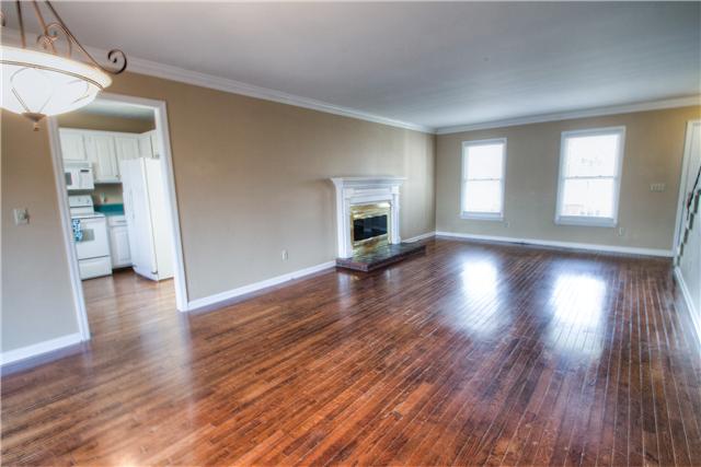 7358 Crow Cut Road Fairview, TN 37062 - Photo 6 of 18 a view of a big room with wooden floor and a kitchen