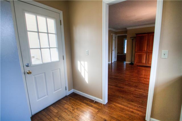 7358 Crow Cut Road Fairview, TN 37062 - Photo 8 of 18 an empty room with wooden floor and windows