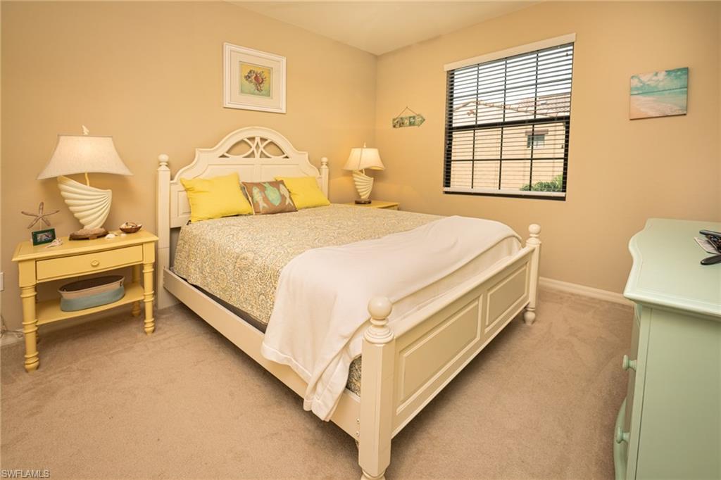 9054 Capistrano Street North, Unit 4002 Naples, FL 34113 - Photo 13 of 26 a bedroom with a bed and a window