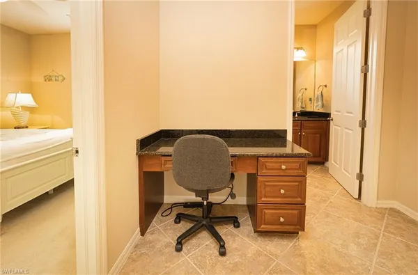 a bedroom with a bed a window and a flat screen tv