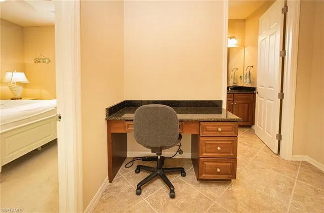 a bedroom with a bed a window and a flat screen tv