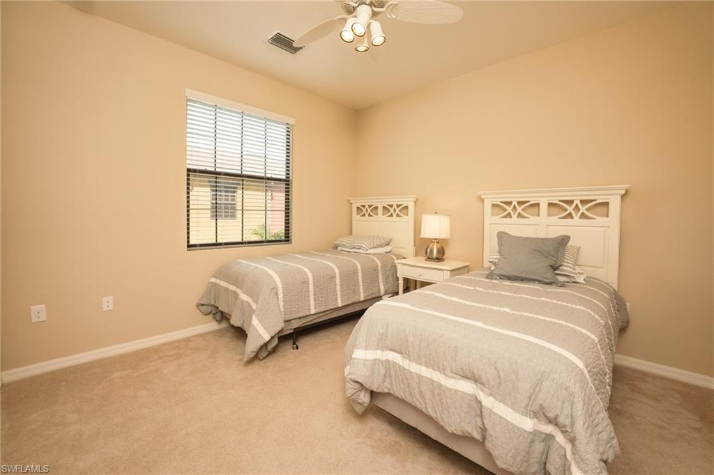 9054 Capistrano Street North, Unit 4002 Naples, FL 34113 - Photo 16 of 26 a spacious bedroom with two beds and a window