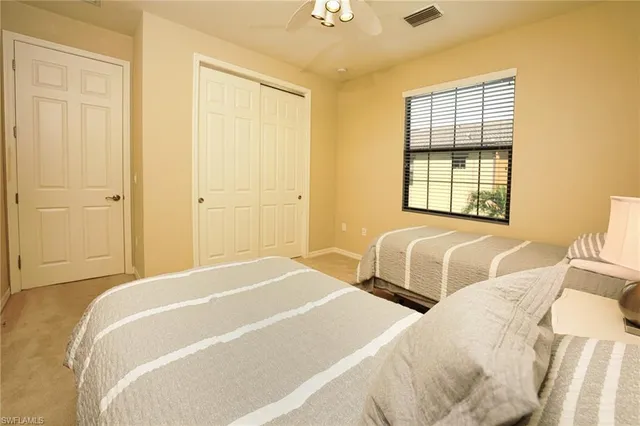 a spacious bedroom with two beds and a window