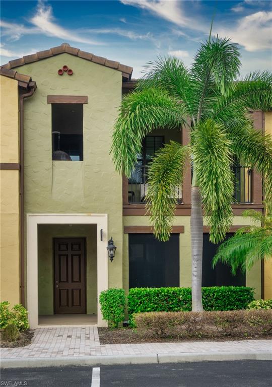 9054 Capistrano Street North, Unit 4002 Naples, FL 34113 - Photo 22 of 26 a front view of a house with a garage
