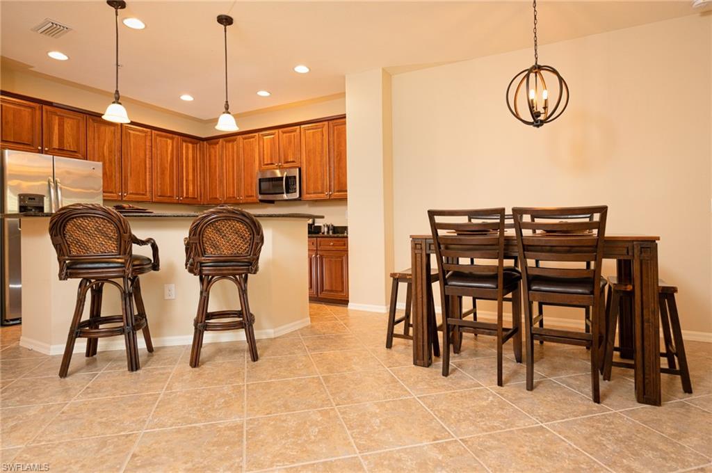 9054 Capistrano Street North, Unit 4002 Naples, FL 34113 - Photo 7 of 26 a view of kitchen with breakfast area