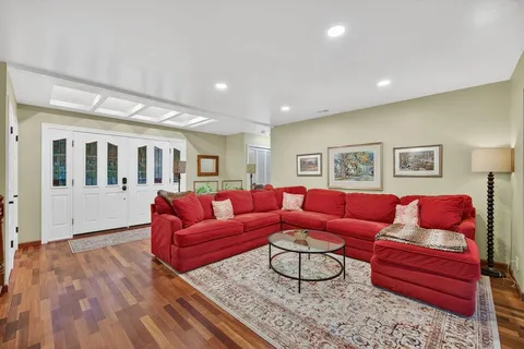a living room with furniture fireplace and window