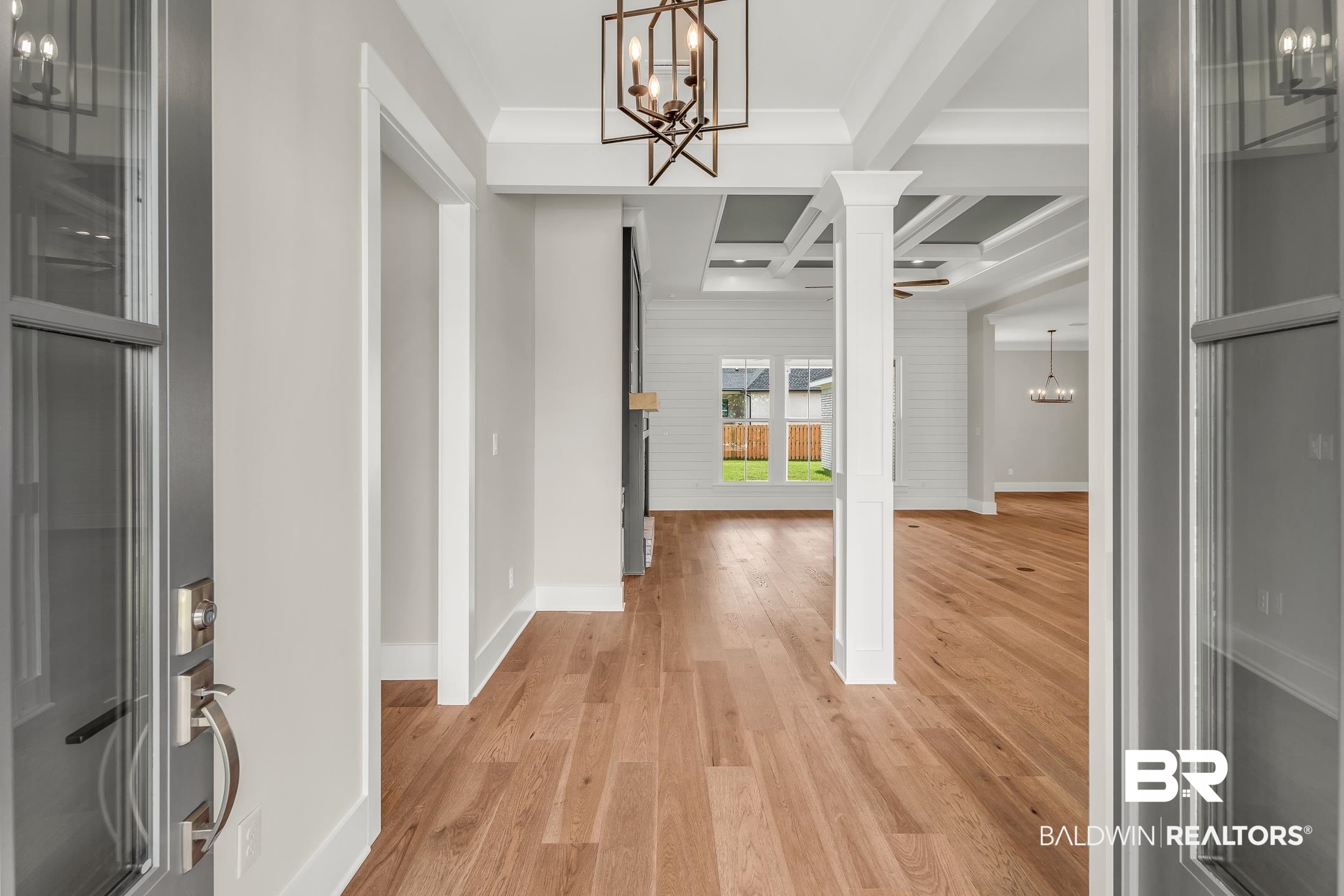 17786 Burwick Loop Fairhope, AL 36532 - Photo 19 of 57 Foyer featuring beam ceiling, light hardwood / wood-style flooring, an inviting chandelier, coffered ceiling, and ornate columns