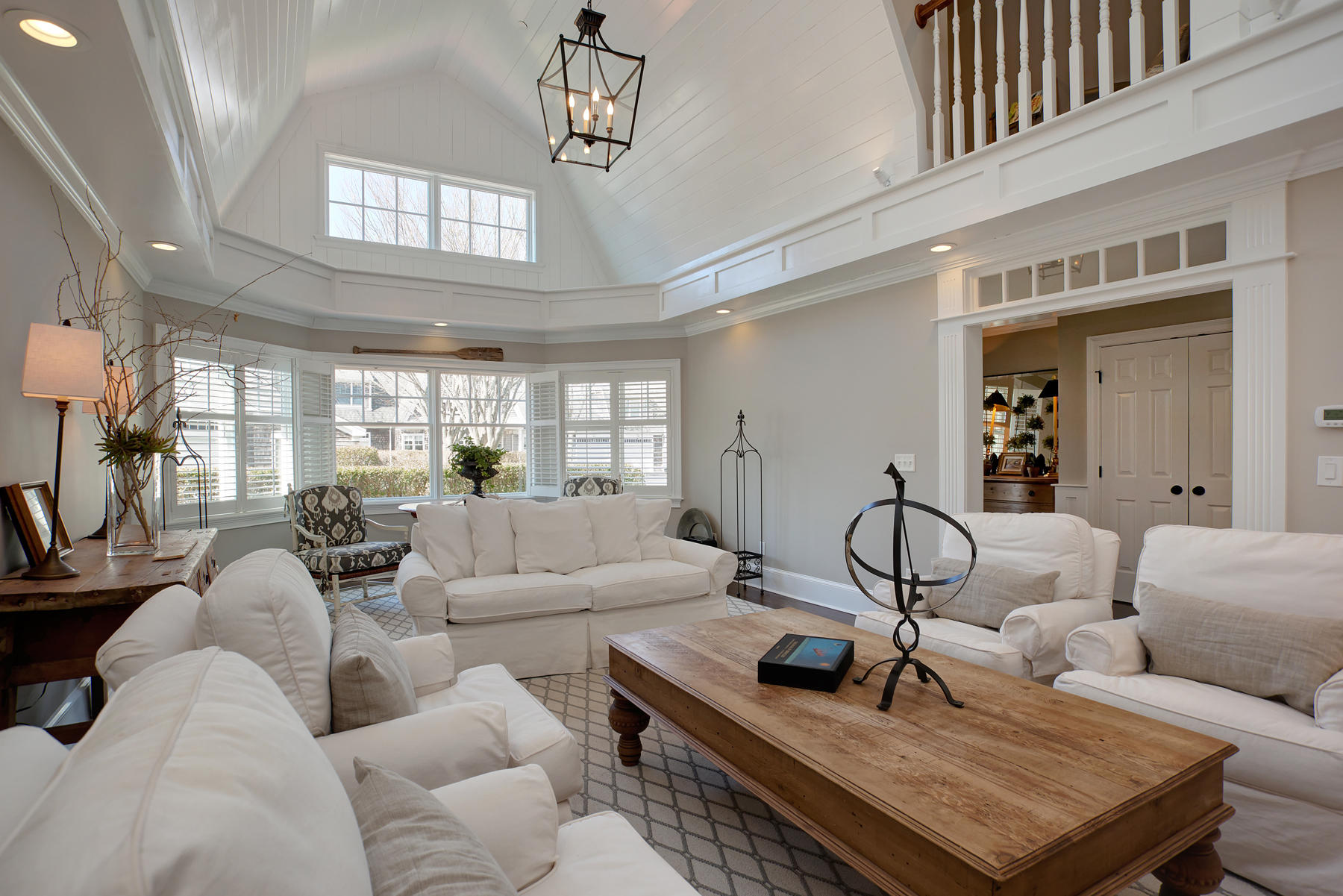 199 East Bay Road, Unit 12 Osterville, MA 02655 - Photo 1 of 40 a living room with furniture and a chandelier