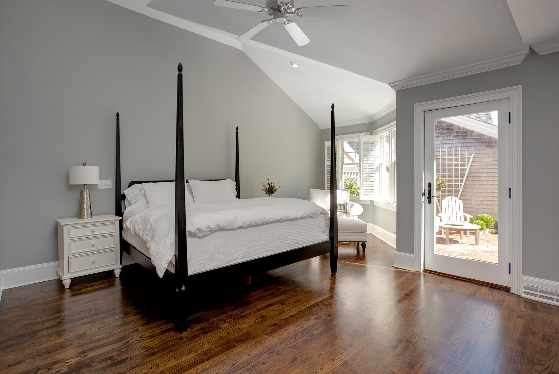 199 East Bay Road, Unit 12 Osterville, MA 02655 - Photo 16 of 40 a bedroom with a bed a table and wooden floor