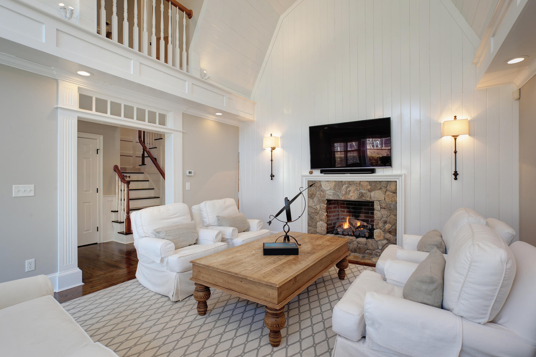 199 East Bay Road, Unit 12 Osterville, MA 02655 - Photo 4 of 40 a living room with furniture a flat screen tv and a fireplace