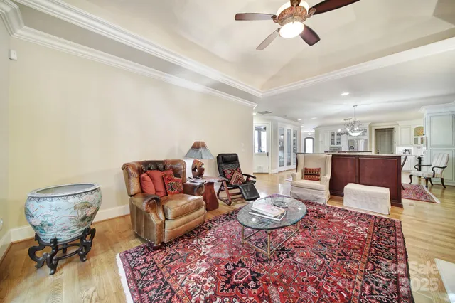 a spacious bedroom with a bed a couch and a flat screen tv