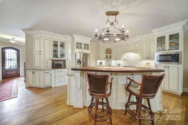 a kitchen with stainless steel appliances granite countertop a stove and white cabinets
