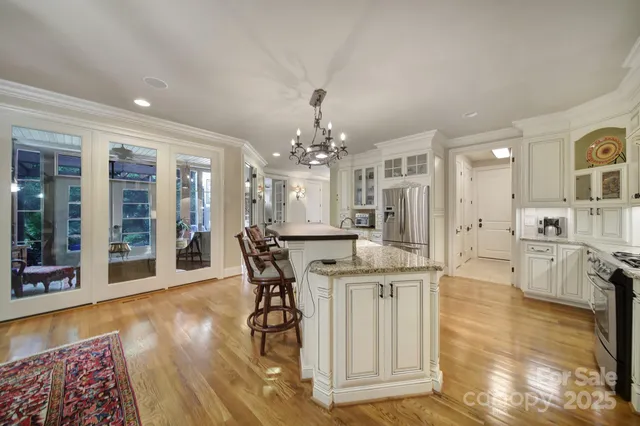 a view of a dining room with furniture and chandelier