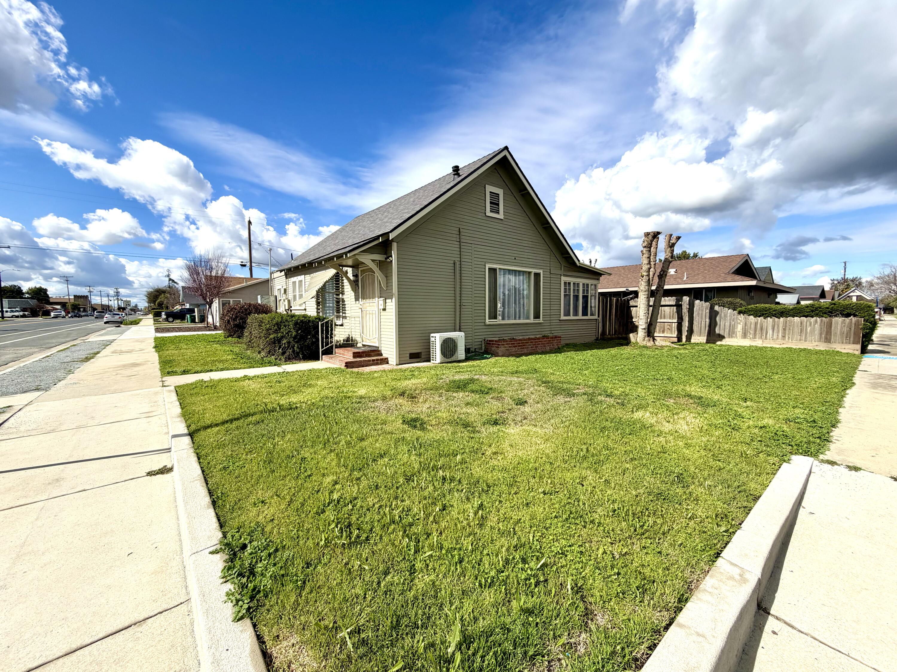 200 North B Street Exeter, CA 93221 - Photo 1 of 20 a view of a house with a big yard and potted plants