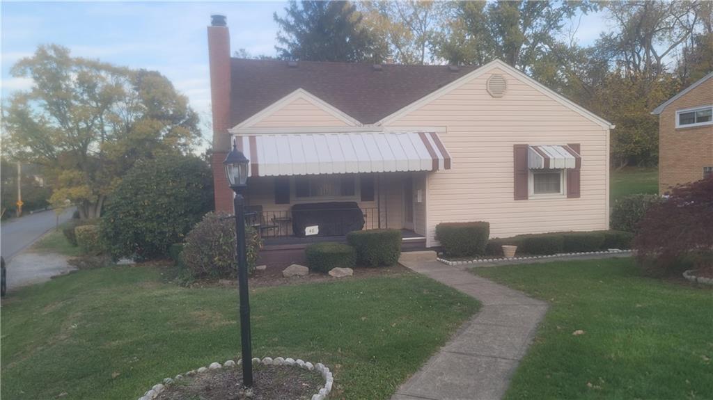 48 Ewing Road McKees Rocks, PA 15136 - Photo 2 of 6 a front view of a house with garden
