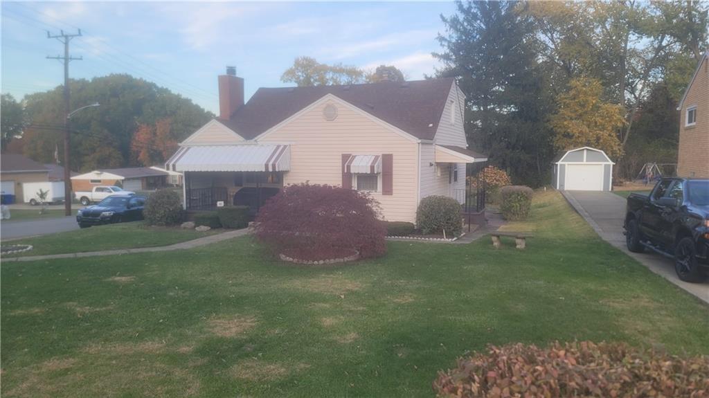48 Ewing Road McKees Rocks, PA 15136 - Photo 3 of 6 a front view of a house with a garden