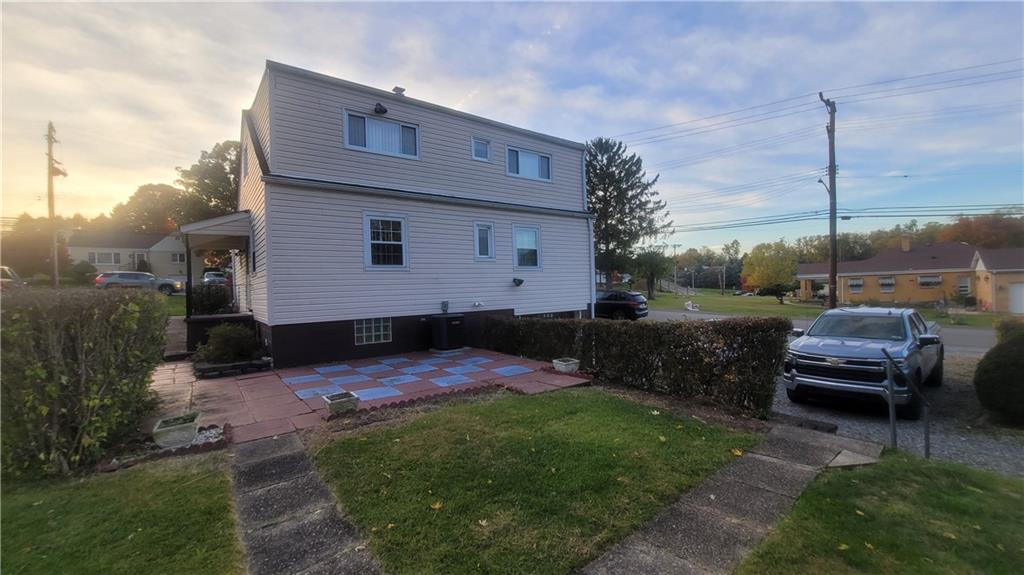 48 Ewing Road McKees Rocks, PA 15136 - Photo 4 of 6 a front view of a house with a garden