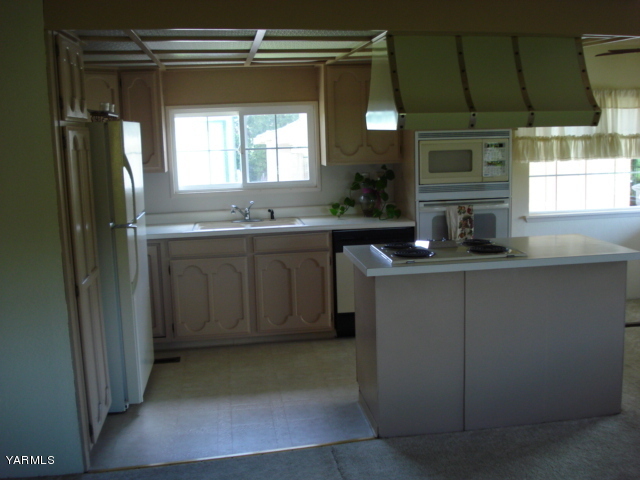 2512 Birchfield Road Yakima, WA 98901 - Photo 5 of 20 a kitchen with stainless steel appliances granite countertop a sink and a refrigerator
