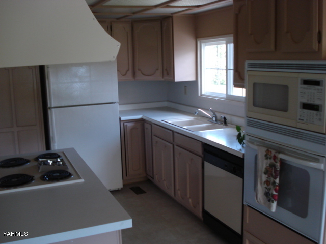 2512 Birchfield Road Yakima, WA 98901 - Photo 6 of 20 a kitchen with a sink stove and refrigerator