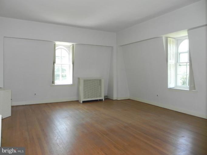 1705 South Road Baltimore, MD 21209 - Photo 10 of 29 an empty room with wooden floor and windows