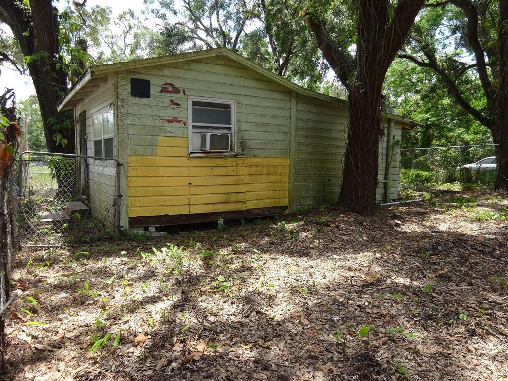 8617 Broad Street New Port Richey, FL 34654 - Photo 2 of 14 a view of a small house with yard and tree in the background