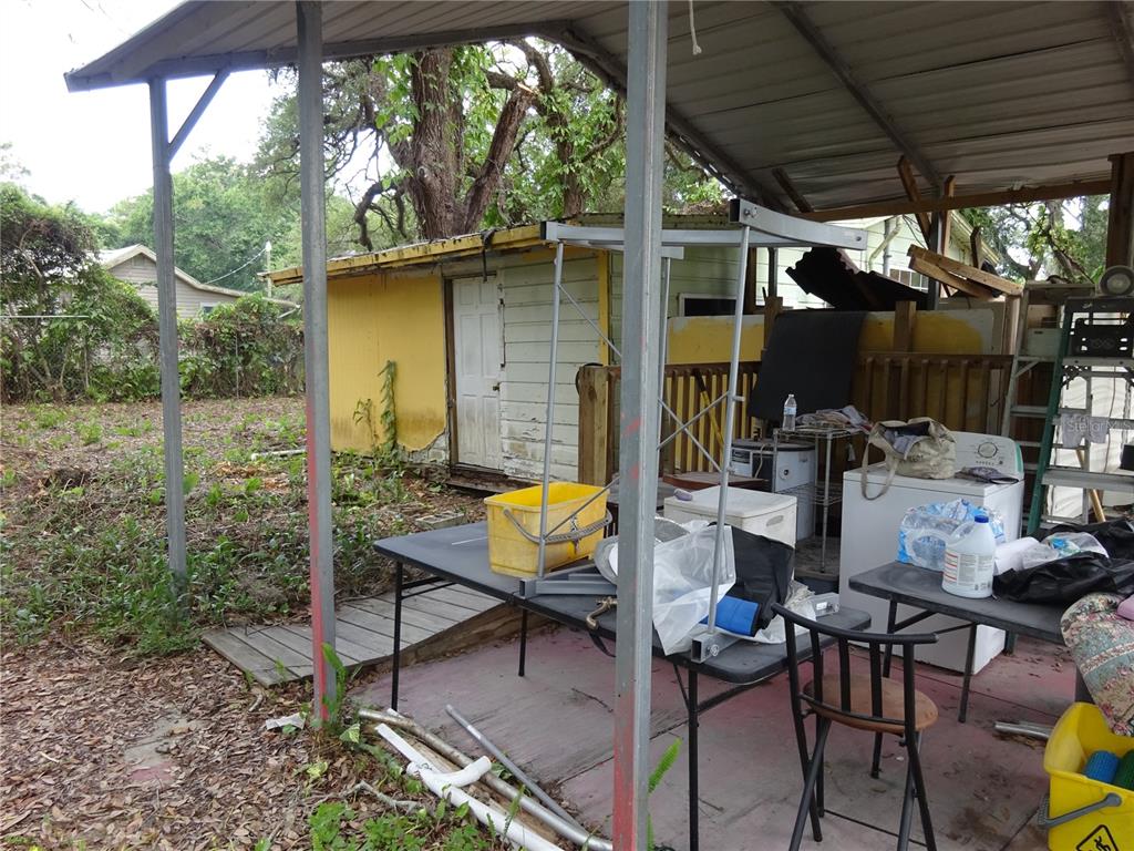 8617 Broad Street New Port Richey, FL 34654 - Photo 4 of 14 a backyard of a house with table and chairs