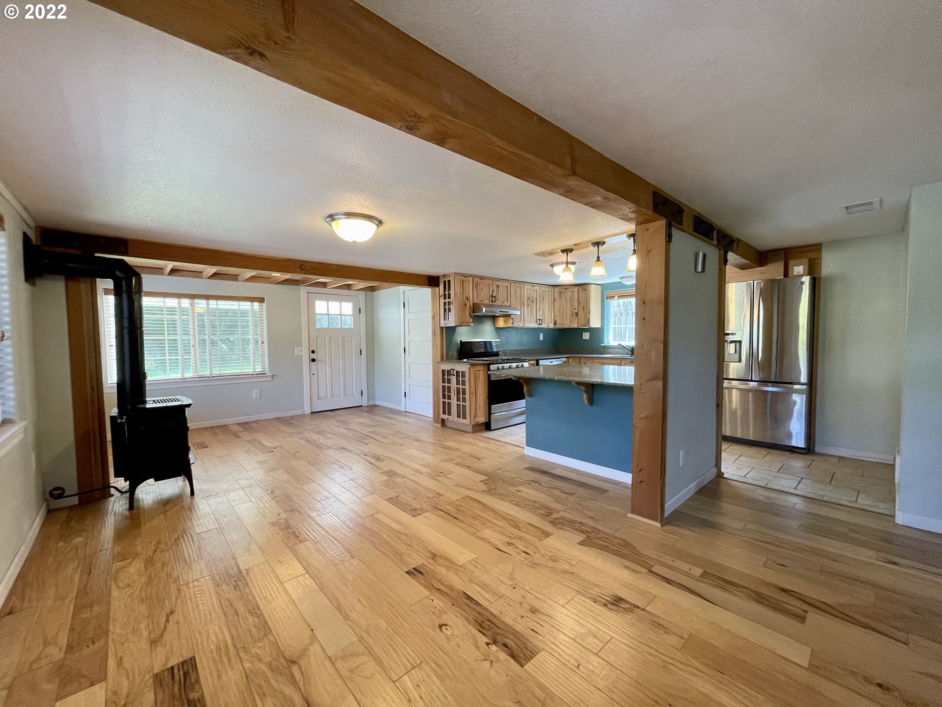 2275 Oak Street North Bend, OR 97459 - Photo 13 of 30 a view of kitchen with refrigerator and wooden floor