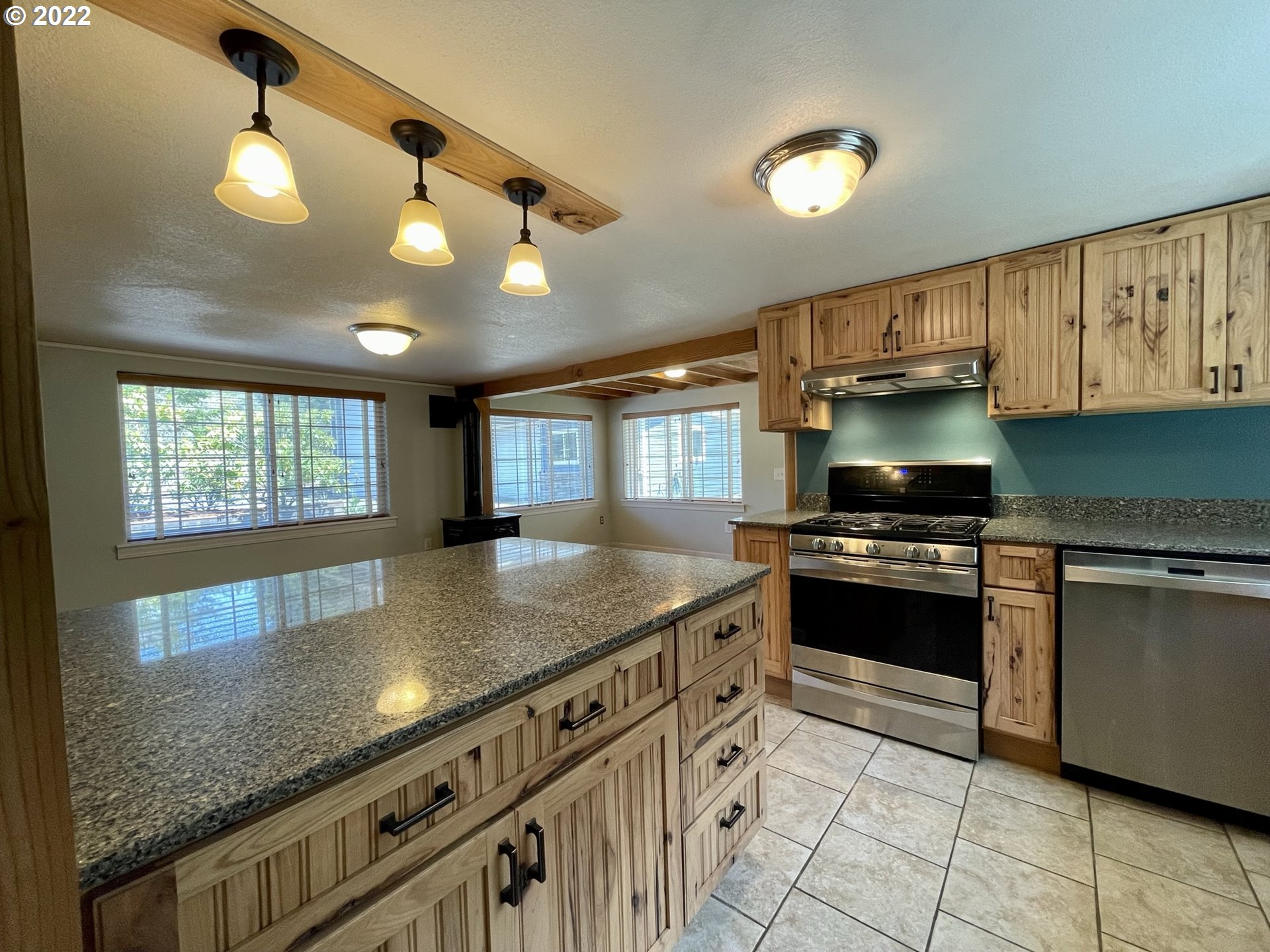 2275 Oak Street North Bend, OR 97459 - Photo 16 of 30 a kitchen with stainless steel appliances granite countertop a sink and a stove
