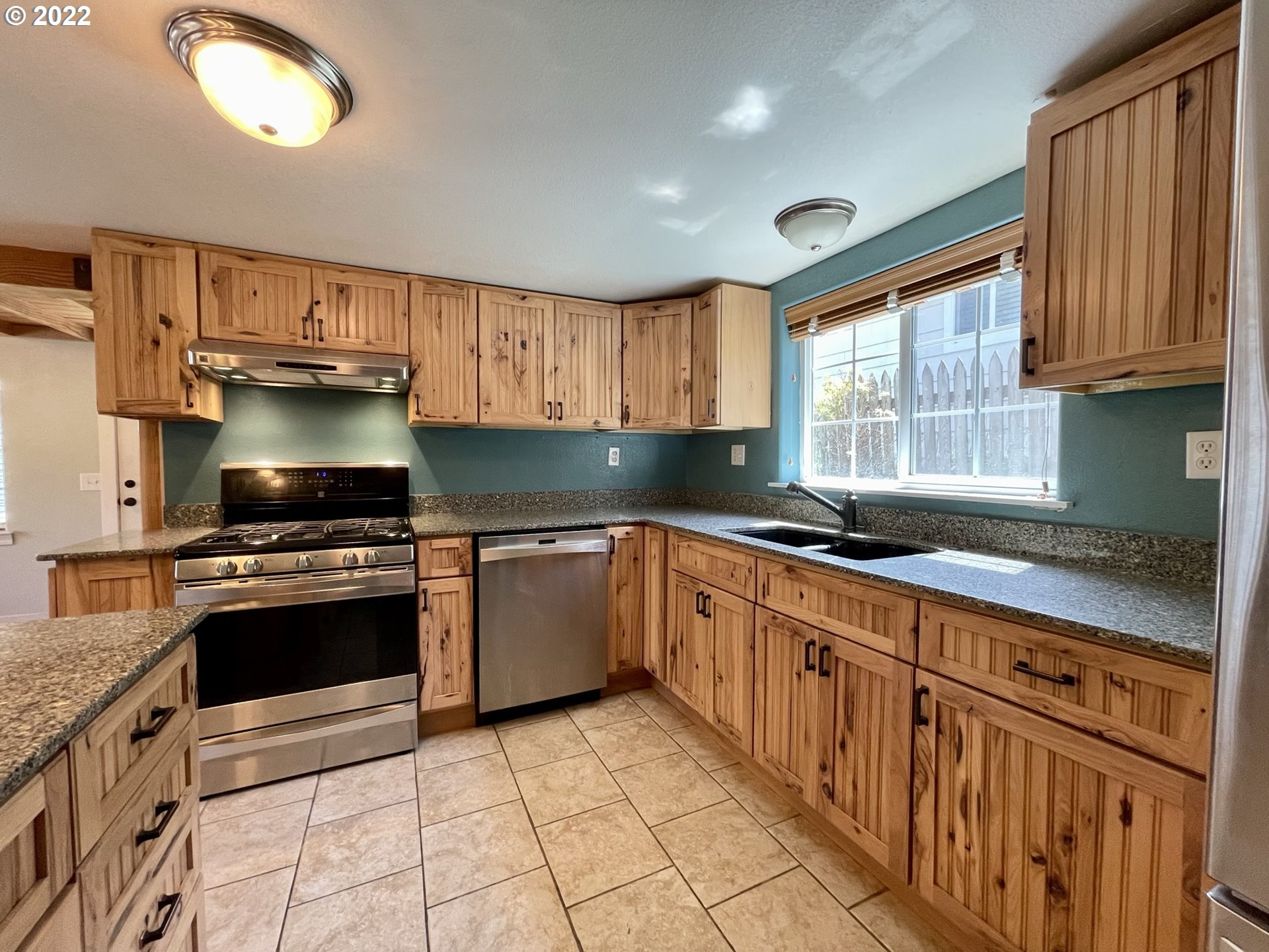 2275 Oak Street North Bend, OR 97459 - Photo 17 of 30 a kitchen with stainless steel appliances granite countertop a stove a sink and a microwave