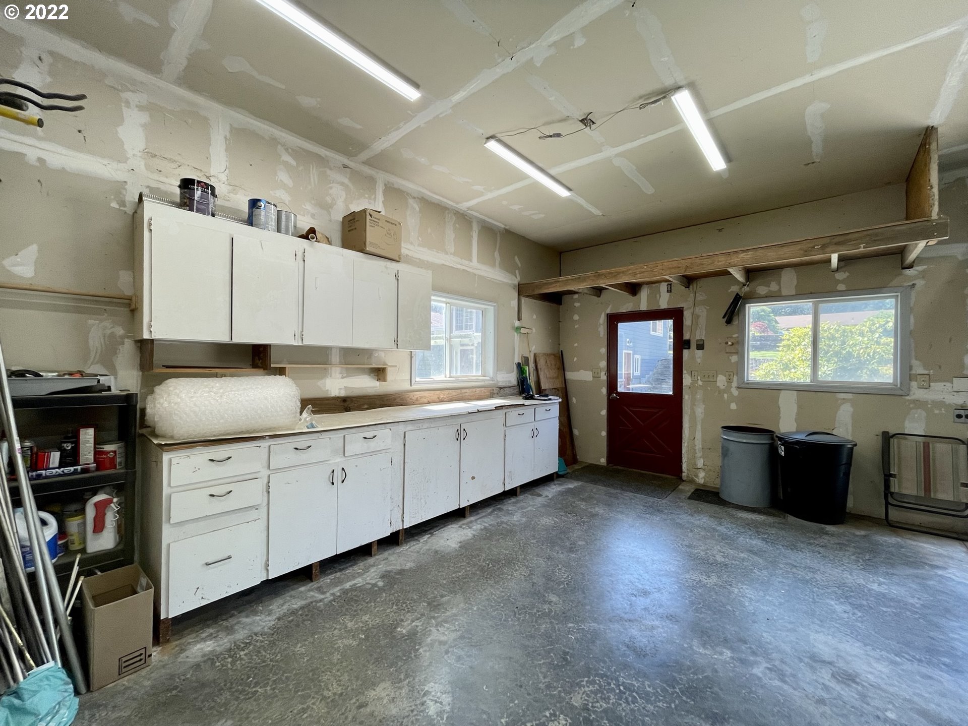 2275 Oak Street North Bend, OR 97459 - Photo 4 of 30 a large white kitchen with stainless steel appliances kitchen island granite countertop a refrigerator and a stove top oven