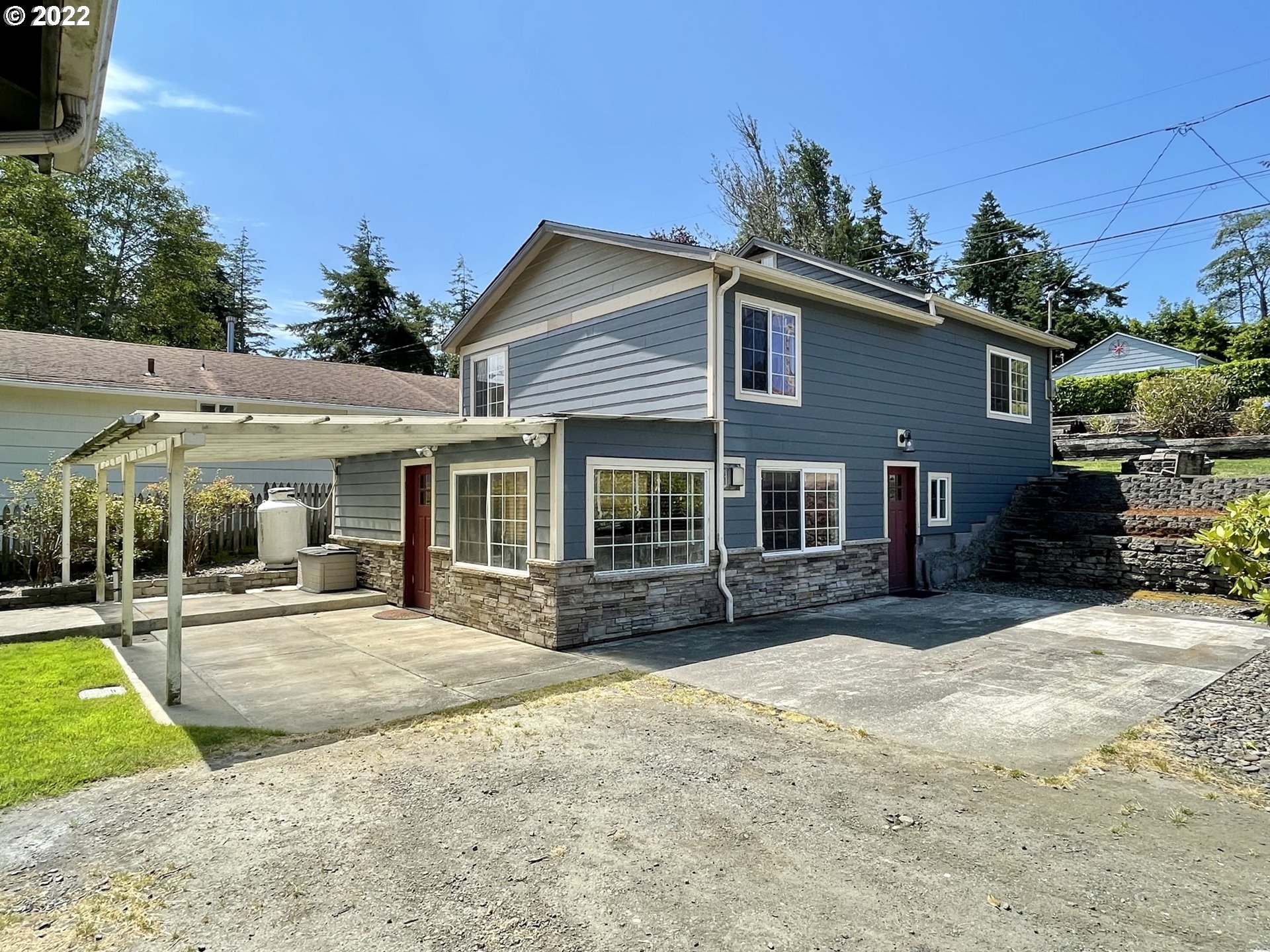 2275 Oak Street North Bend, OR 97459 - Photo 8 of 30 a front view of a house with a yard and potted plants