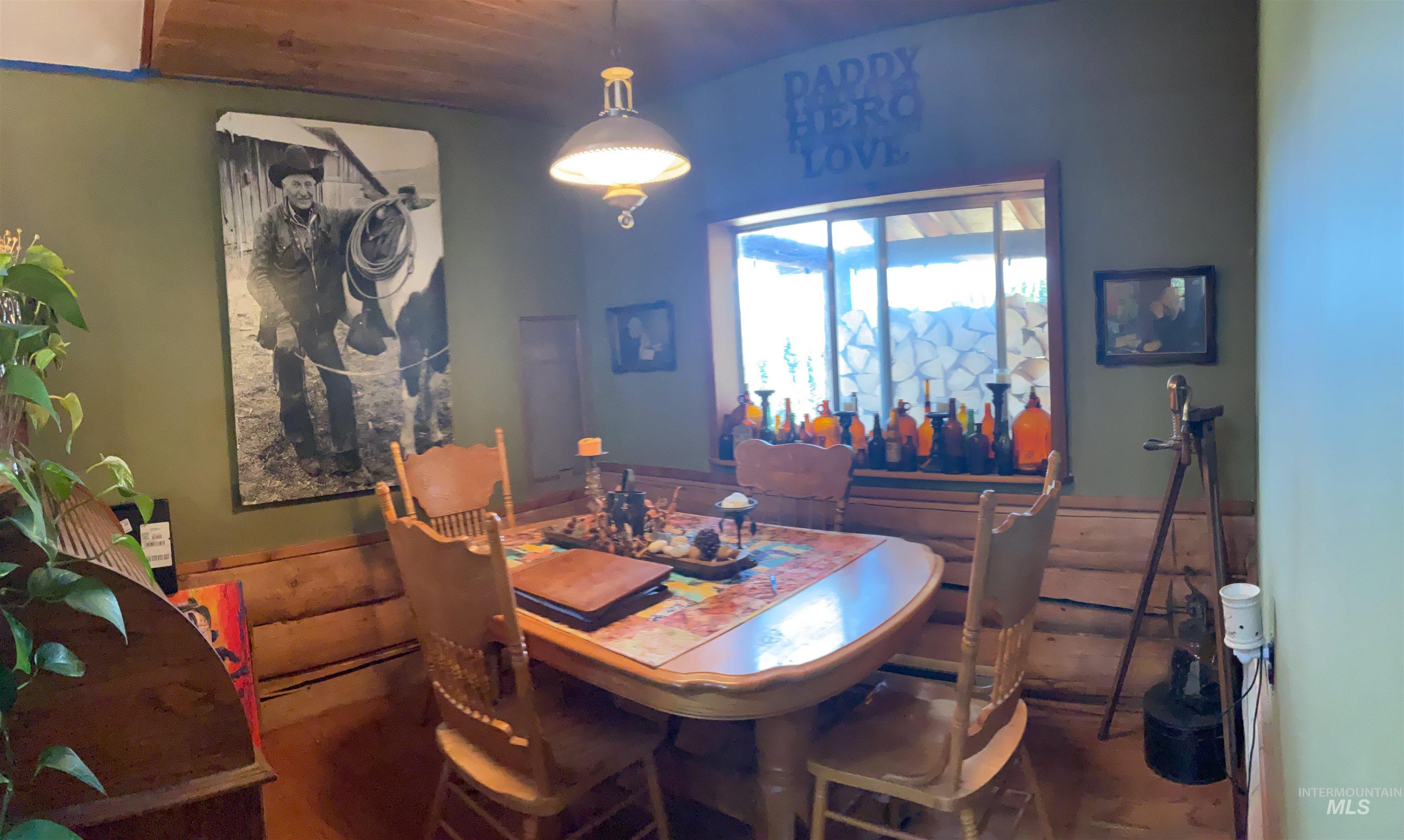 176 West Buffalo Gulch Road Elk City, ID 83525 - Photo 14 of 38 Dining area featuring wood-paneled walls and a built-in wood bench
