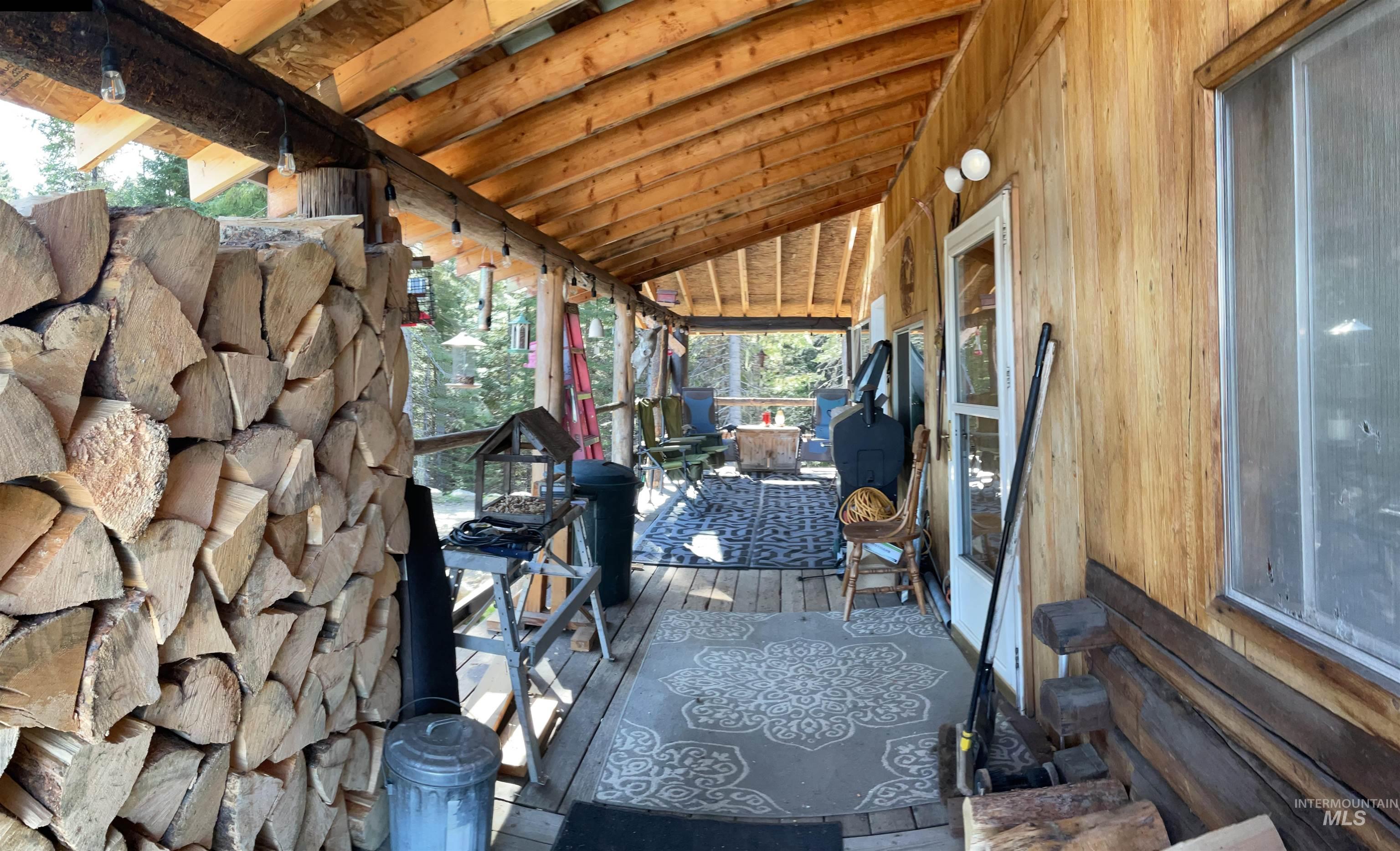 176 West Buffalo Gulch Road Elk City, ID 83525 - Photo 26 of 38 Expansive covered porch featuring a natural wood ceiling, wood-finish flooring, and exposed wood beams