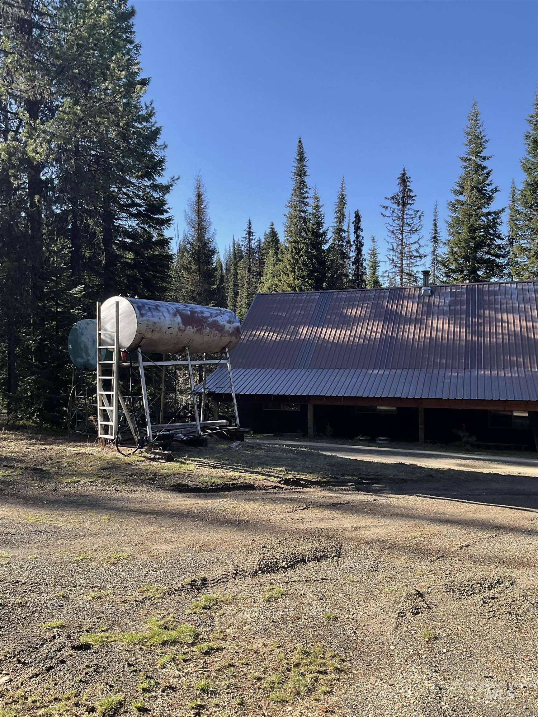 176 West Buffalo Gulch Road Elk City, ID 83525 - Photo 32 of 38 Metal-roofed structure surrounded by mature evergreen trees
