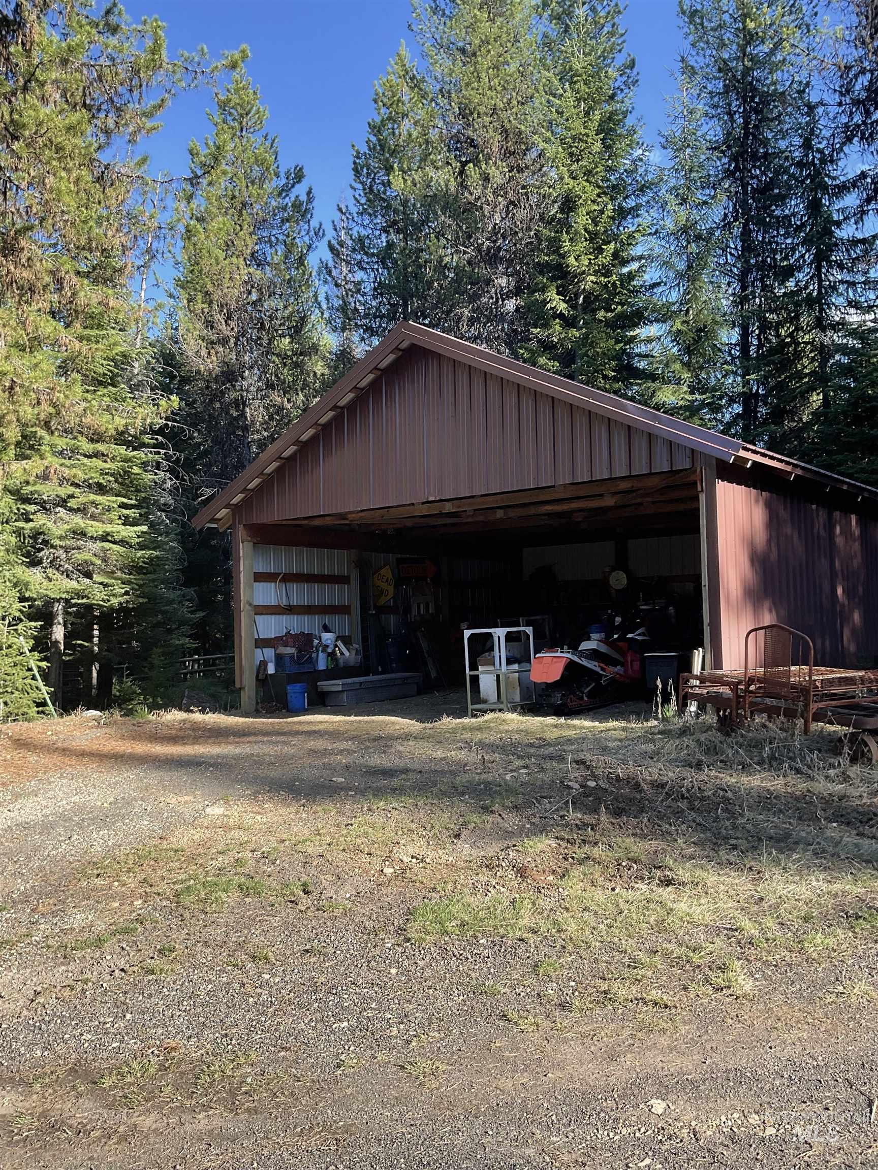 176 West Buffalo Gulch Road Elk City, ID 83525 - Photo 38 of 38 Spacious carport structure featuring a durable metal roof, exposed wood framing, and a gravel foreground