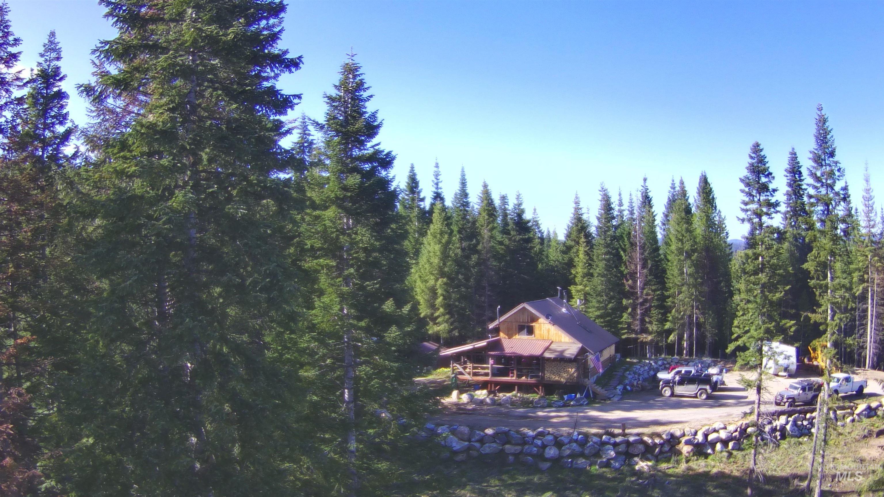 176 West Buffalo Gulch Road Elk City, ID 83525 - Photo 6 of 38 Wood-sided cabin-style residence surrounded by dense evergreen trees