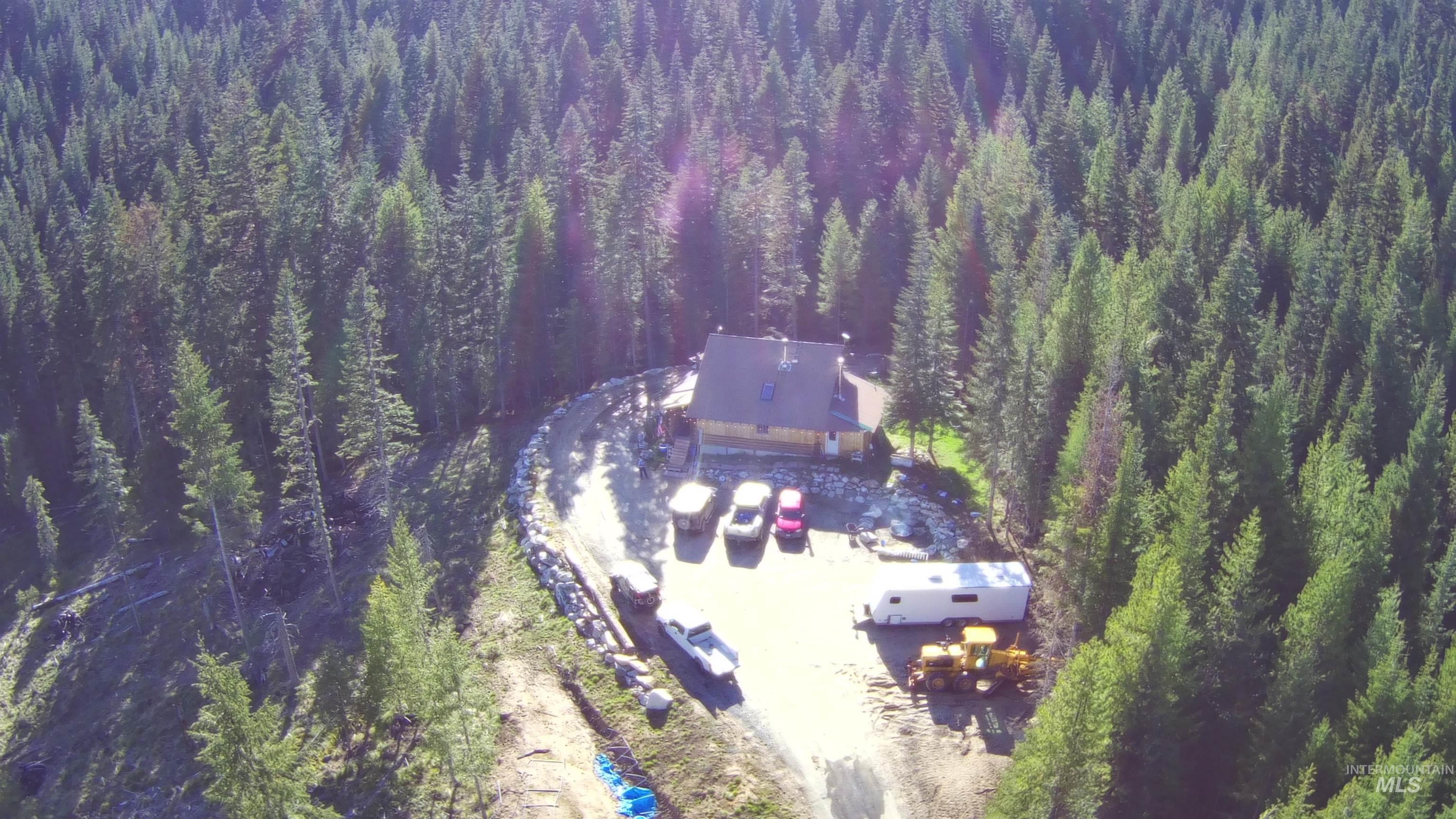 176 West Buffalo Gulch Road Elk City, ID 83525 - Photo 9 of 38 Cabin-style residence surrounded by a dense forest of evergreen trees