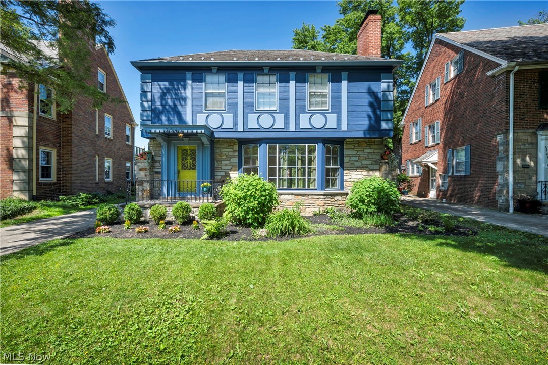 3543 Lytle Road Shaker Heights, OH 44122 - Photo 2 of 49 Blue facade residence featuring a stone foundation, a yellow entry door, a bay window, and a brick chimney